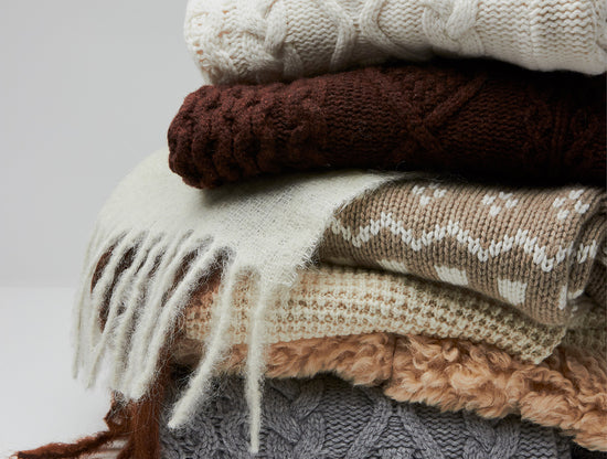STACK OF WOMEN'S SWEATERS